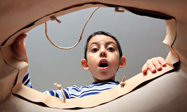 child looking inside bag with surprise